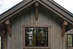 a wooden building with two windows on each side