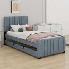 a bed sitting on top of a hard wood floor