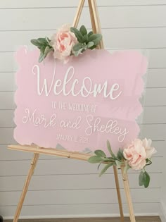 a welcome sign with flowers on it