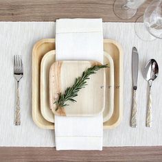 a place setting with silverware and napkins