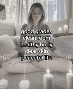 a woman sitting on the floor with candles in front of her and text that reads, good