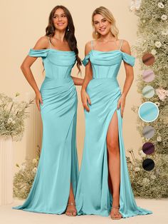 two women in blue dresses standing next to each other with their hands on their hips