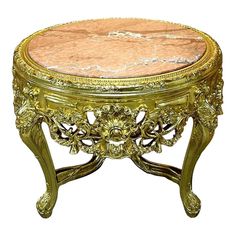 an ornately decorated gold and marble coffee table with flowers on the top, sitting in front of a white background