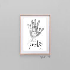 a family hand print hanging on the wall