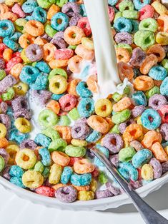 a white bowl filled with cereal and milk being poured into the mixture to make it look like they are made from cereal