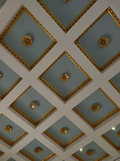 the ceiling is decorated with gold and blue tiles