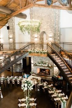 an indoor wedding venue with tables and chairs set up in front of the fire place