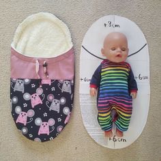 a baby doll is laying next to a bib