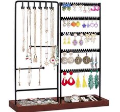 a jewelry rack with many different necklaces and earrings on it's display shelf