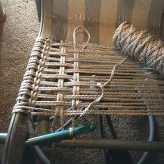 a chair that has some rope on top of it and two blue scissors next to it