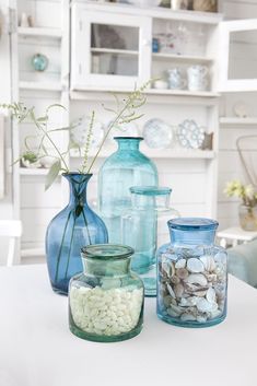 vases and jars are lined up on the table