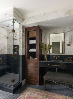 a black and white bathroom with marble walls