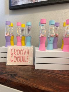 there are many toy blenders sitting on the counter next to a sign that says groovy cookies