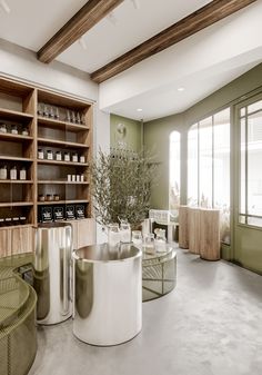 a room with shelves, tables and stools in it