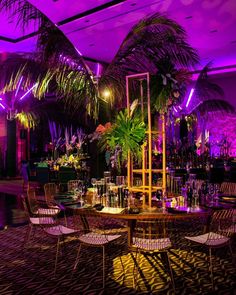 a dining room with purple lighting and palm trees