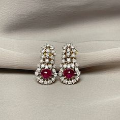 Cabochon Ruby with Diamond Drop Earrings The combination of Cabochon Rubies and Diamonds creates a timeless and versatile piece. A luxurious cabochon ruby, known for its smooth, rounded shape and rich, vibrant color that captures the light beautifully. This pair of chandelier earrings is set in 18K Yellow and White Gold. The elegant drop style offers a graceful movement, making these earrings perfect for formal occasions and everyday wear. For any questions or additional information, please don' Luxury Oval Ruby Earrings, Formal Ruby Gemstone Diamond Earrings, Ruby Gemstone Diamond Earrings For Formal Occasions, Luxury Ruby Gemstone Earrings, Exquisite Round Ruby Earrings, Luxury Cabochon Earrings For Wedding, Elegant Ruby Diamond Earrings, Classic Ruby Earrings For Formal Occasions, Luxury Hallmarked Ruby Earrings