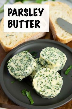 parsley butter on a black plate with bread in the background and text overlay that reads parsley butter