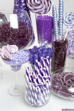 purple and white candies, lollipops, marshmallows in glass vases