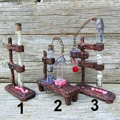 an image of three miniature bottles in the shape of animals and birds on wooden planks