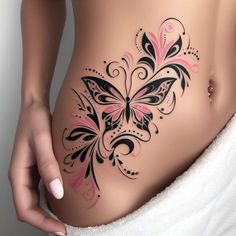 a woman's stomach with black and pink butterflies on the side by her belly