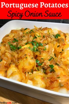 potatoes with onions and parsley in a white casserole dish