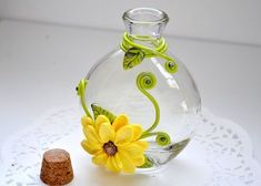 a glass vase sitting on top of a white doily