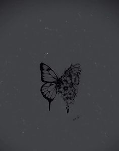 a black and white photo of a butterfly with flowers on it's back side