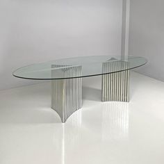 a glass table sitting on top of a white floor