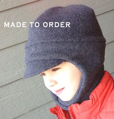 a young boy wearing a hat with the words made to order written on it