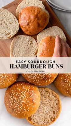 hamburger buns on a cutting board with the words easy sourdough hamburger buns