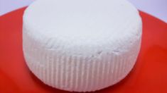 a white cake sitting on top of a red plate