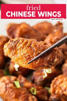 fried chinese wings with chopsticks being held up to the camera and text overlay reads fried chinese wings