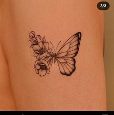 a small butterfly with flowers on the side of her thigh, and an arrow in the middle