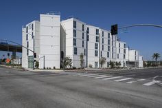 an empty street in front of a large white building