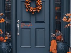 the front door is decorated with pumpkins and flowers