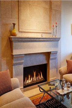 a living room filled with furniture and a fire place in the middle of the room