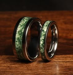 two wedding bands with green and black marble inlays