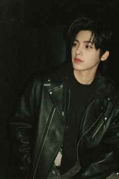 the young man is wearing a black leather jacket