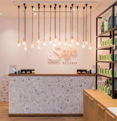 the inside of a store with lights hanging from the ceiling