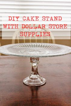 a glass cake stand on top of a wooden table with the words diy cake stand with dollar store supplies