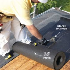 a man working on a flat roof with the help of a taper and hammer