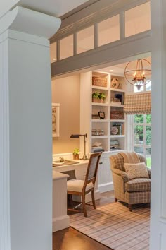 a living room filled with furniture next to a window