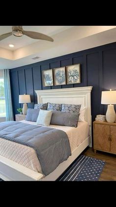 a bedroom with blue walls and white furniture