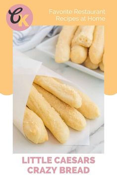 bread sticks sitting on top of a white plate next to a bowl of doughnuts