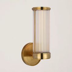 an image of a wall light that is in the shape of a cylinder with pleated glass shades