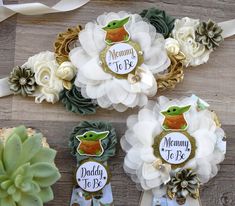 three baby shower hair clips with flowers and succulents