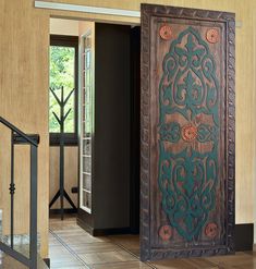 an ornate wooden door in the middle of a room