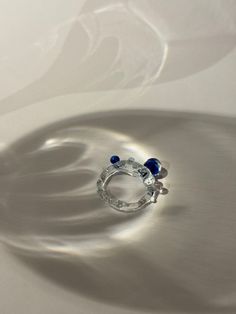 One-of-a-kind unique handmade borosilicate glass ring with translucent blue pebbles and a beautiful clear ring band.  Hi, nice to digitally meet you :) My name is Maureen I am a 20-something jewellery artist with a specialisation in glass jewellery located in the Netherlands. The ring you are currently looking at is formed using a technique called lampworking. It is made from borosilicate glass also called medical-grade glass as it is the sturdiest kind of glass.  Each jewel is unique as I handcraft every piece of glass individually.  I am also open to individual requests 💠⚒️💎 Please do not hesitate to ask me any questions :) Blue Pebbles, Glass Jewellery, Glass Ring, Handmade Jewelry Tutorials, Glass Rings, Artistic Jewelry, Ring Band, Handmade Artisan, Jewelry Tutorials