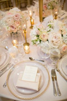 an image of a table setting with flowers and candles