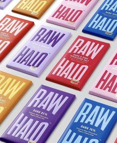 rows of raw halo chocolate bars in different colors and flavors on a white surface with the words raw halo printed on them